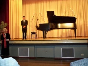 Skye McGregor presents the piano to the YMC with  Evgeny about to perform